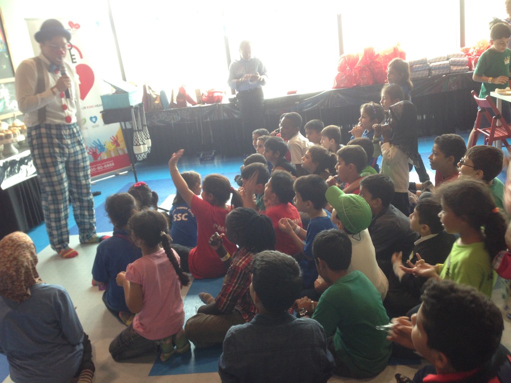 Children enjoying the magic show and balloon sculpture clown