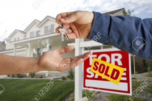 5841622-Handing-Over-the-House-Keys-in-Front-of-a-Beautiful-New-Home--Stock-Photo