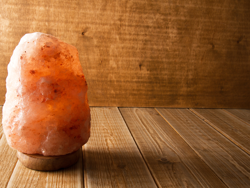 Himalayan salt lamp on wooden background