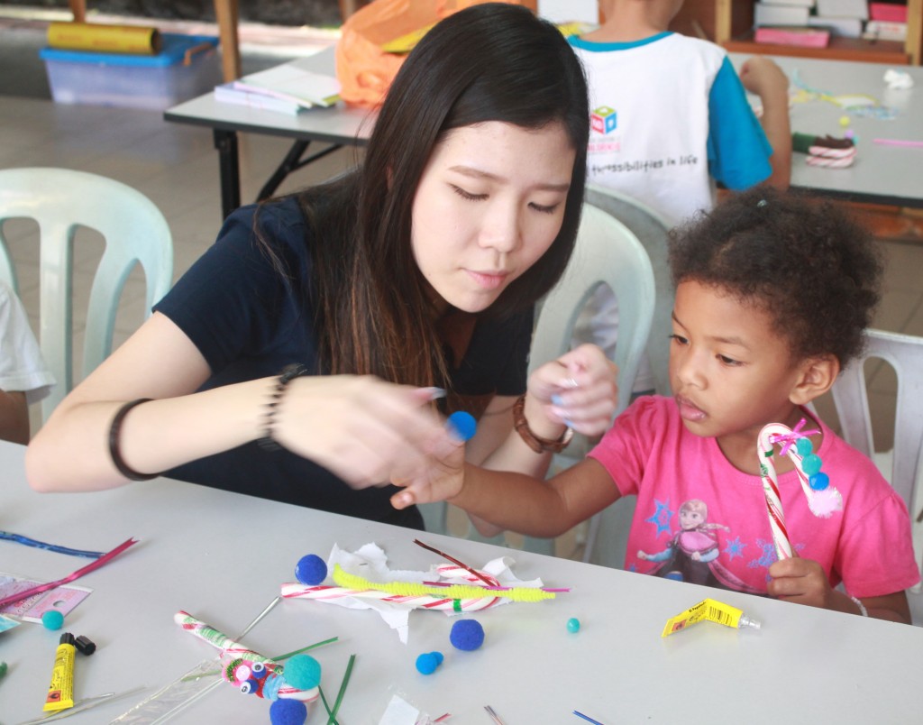 SkyWorld team decorates the candy canes with children of Rumah Charis