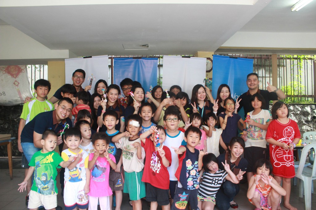 The children of Rumah Charis presenting their decorated candies intended for SkyWorld to help raise funds for their home