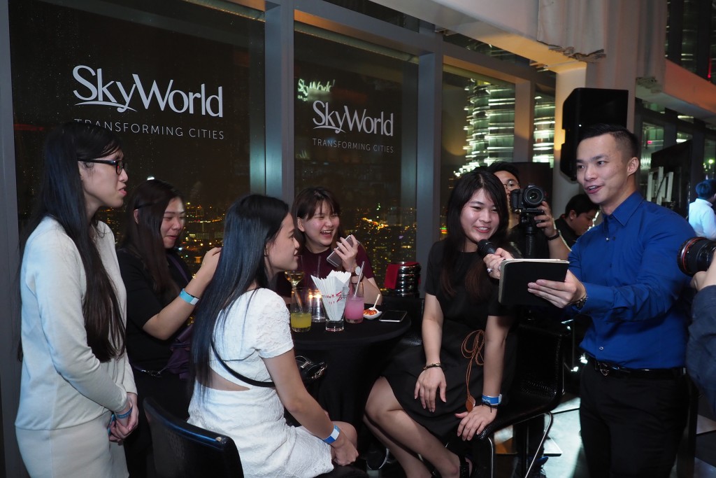 The emcee engaging with party guests during the KLCC event launch