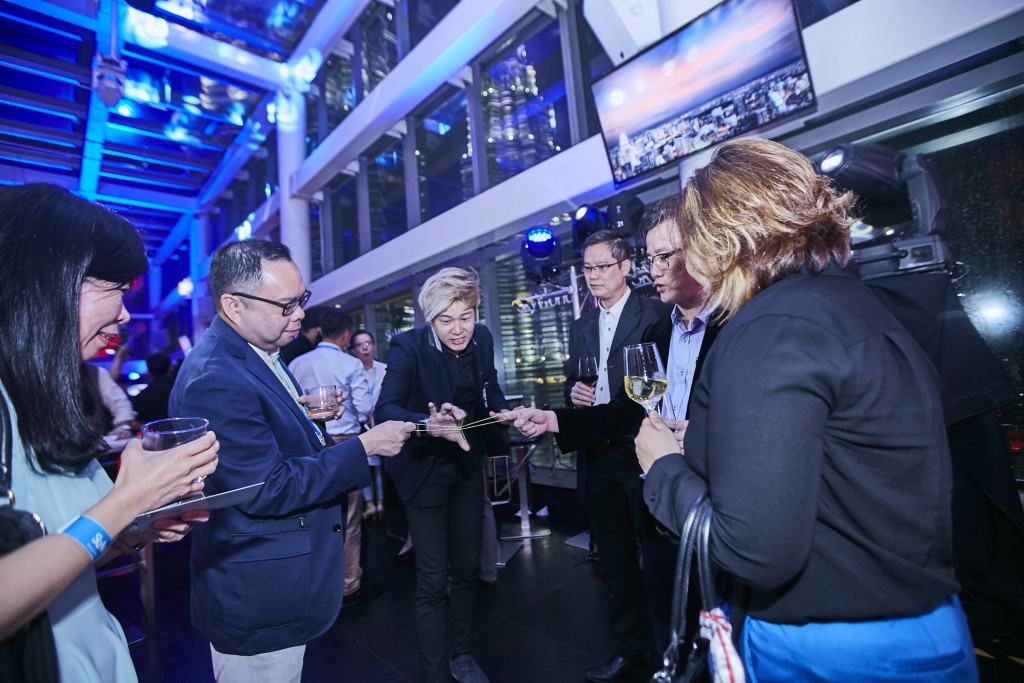 Live magic performances enlivens the crowd during the roof-top party